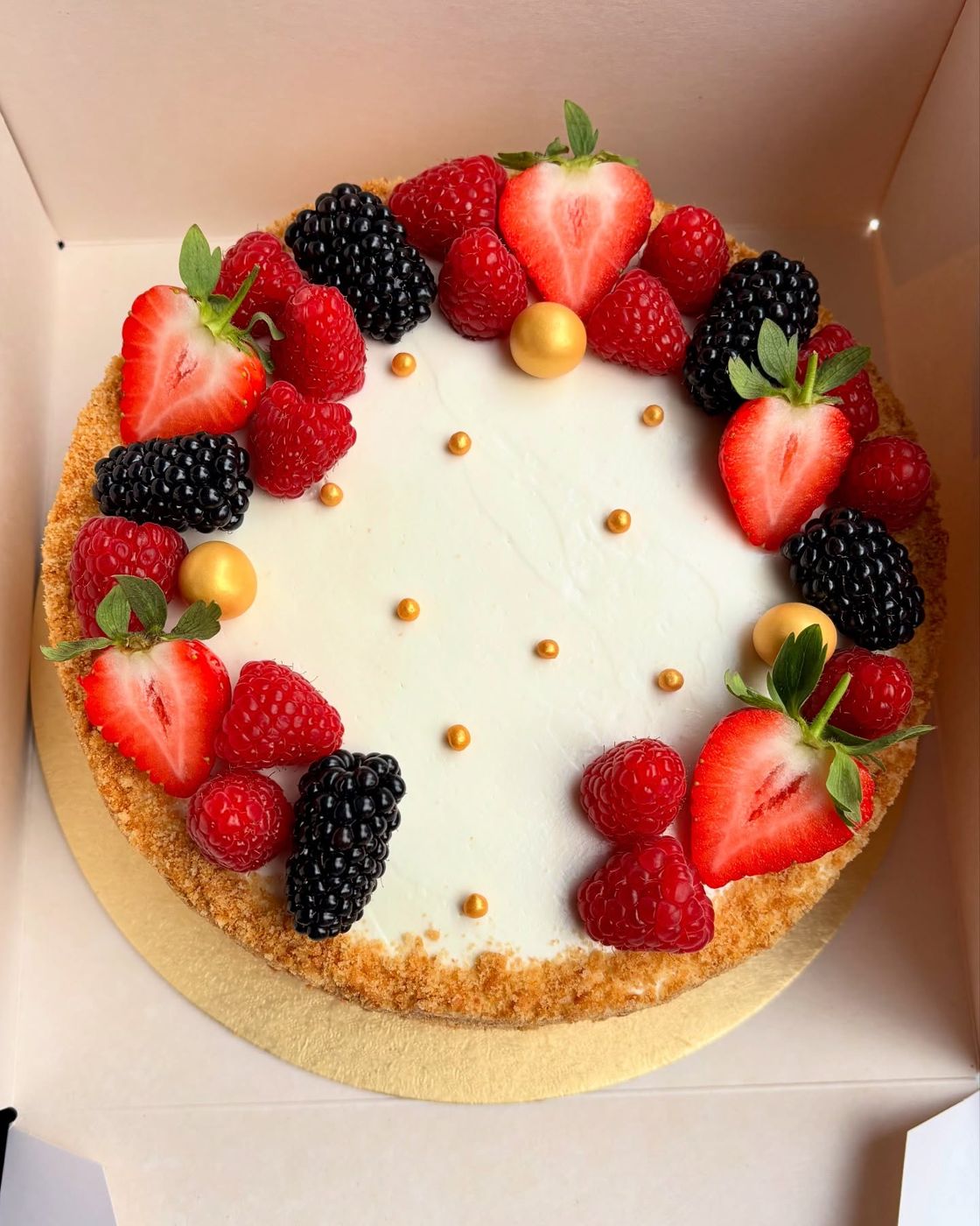 A classic honey cake topped with fresh berries
