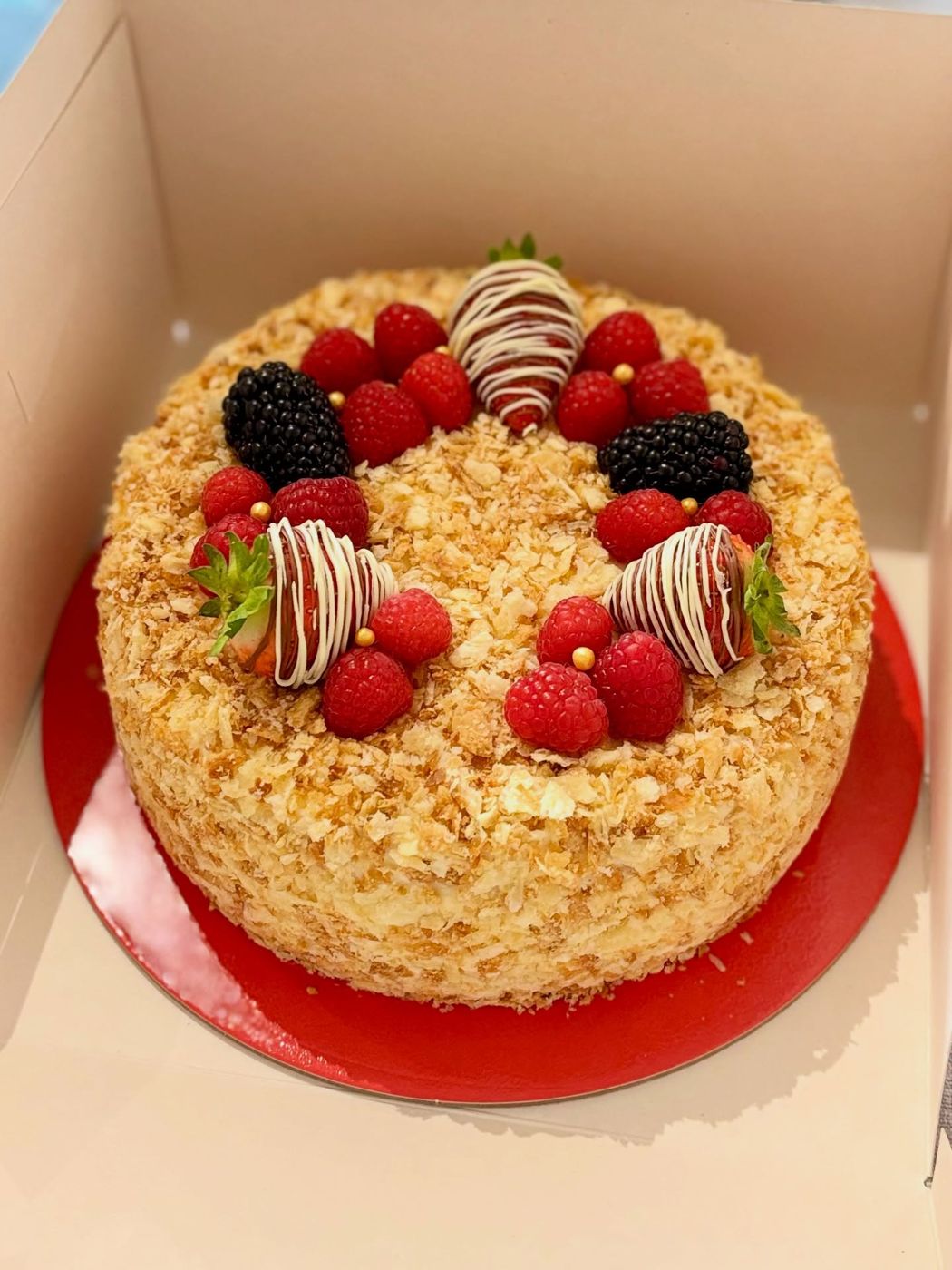 A raspberry Napoleon cake with chocolate-dipped strawberries
